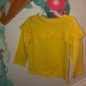 YELLOW ruffle top.